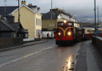 Castel Caernarfon and its train depart over Britannia Bridge - Andrew Thomas