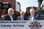 Pete Waterman, Dr John Prideaux, Chairman of the Ffestiniog & Welsh Highland Railways and Lord Dafydd Elis Thomas pose at Pont Croesor with the banner marking the opening of the Welsh Highland Railway. Pic: Chris Parry