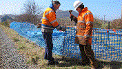 Erecting blue barrier fence at Pen y Mount - David Firth