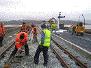 Shovel packing the WHR loop, paving in progress, and in the background signal 2A on a post to be shared with signal 1 - Stuart McNair